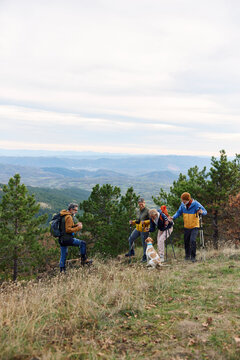 Group of people spend day on a mountain 
