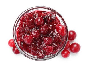 Tasty cranberry sauce in glass bowl and berries isolated on white, top view