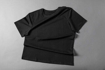 One t-shirt on grey background, top view