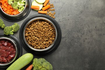 Dry pet food and natural products on grey table, top view. Space for text