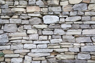 Old stone wall of the fortress. Background. Texture. Atmosphere of history.