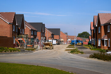 Construction site with new houses under development in clear weather