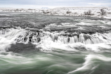 Obraz premium long exposure ice winter Iceland water running waterfall