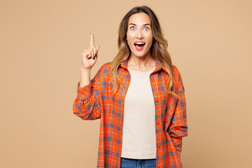 Young insighted smart proactive woman wear orange shirt casual clothes holding index finger up with...