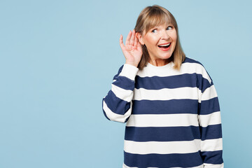 Elderly curious nosy blonde woman 50s years old wear striped sweatshirt casual clothes try to hear...