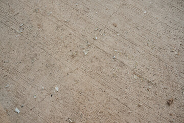 This image features a closeup view of a concrete floor that is scattered with a multitude of small stones, adding texture and interest