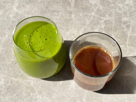 Cup of fresh green smoothie and a cup of coffee