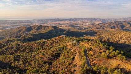 Obraz premium Aerial view of mountainous landscape at sunset.
