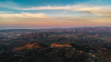 Fototapeta premium Aerial view of a mountainous landscape at sunset.