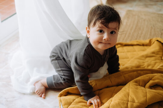 Baby crawling on the floor with funny face