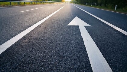 Asphalt road with white arrow marking. Straight path ahead.