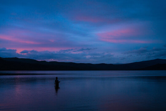 Fishing Beneath Colorful Dusk Skies
