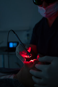 Dentist performs advanced dental procedure with laser tool