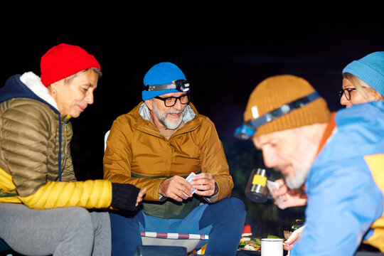 Friends enjoying themselves in the camp by night