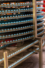 Close-up view of empty blue metal conveyer belt in industrial building. Soft focus. Copy space. Manufacturing and food production line theme.