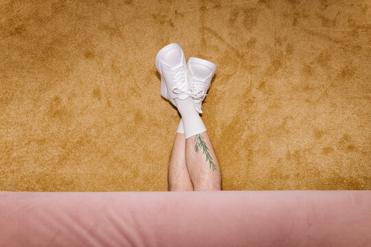 Creative Concept of Tattooed Legs in White Sneakers
