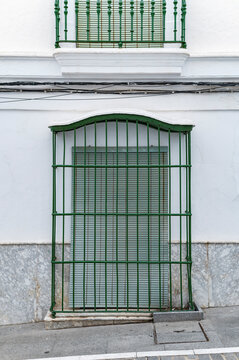 Green barred window with marble base