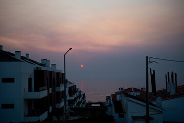 Red fire sun by sea town
