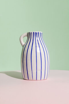 Stylish ceramic vase in soft pastel background