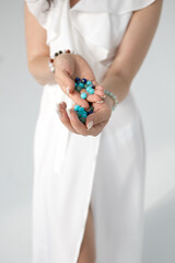 a bracelet made of natural stones in women's hands. photo. vertical