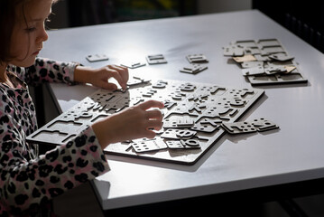 Little child touches with fingers alphabet letters in Braille
