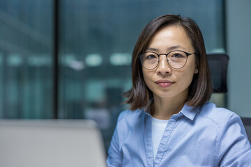 Close-up portrait of a young serious businesswoman, Asian woman is confident and thinking looking...