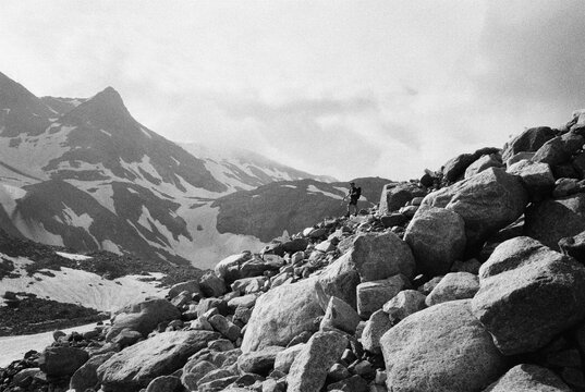 Solo Hiker in Dramatic Alpine Landscape with Large Boulders