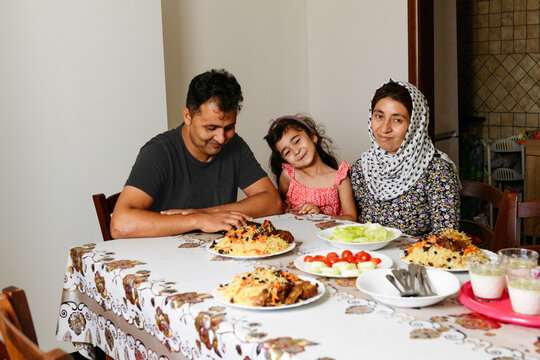 Smiling afghan family at the table