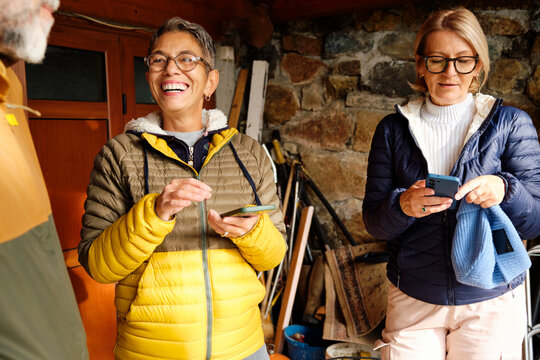 Friends enjoy conversation in front of the cabin