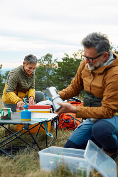 Man and woman are setting up camp
