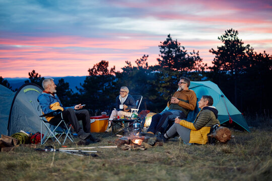 Friends camping at sunset