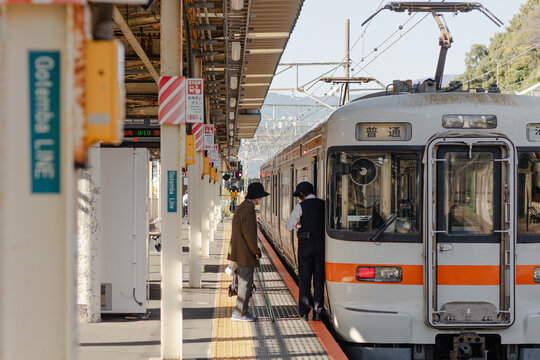 A Passenger boarding a train at a station in Japan