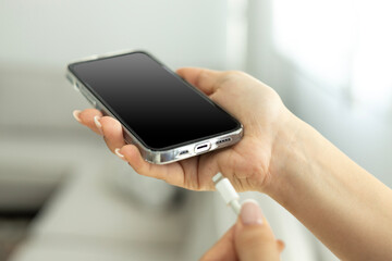 Hand charging phone with usb cable at home