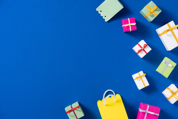 Colorful Gift Boxes and Shopping Bag on Vibrant Blue Background