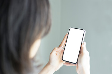 Close up woman hand holding a smartphone blank white screen