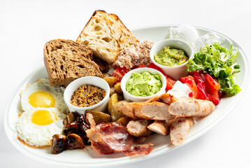 A colorful breakfast platter featuring poached eggs, assorted breads, fresh vegetables, olives, assorted spreads, and meats. Perfect for food-related projects and culinary promotions.