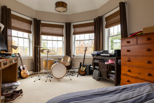 Drum set and guitar in child home bedroom decor