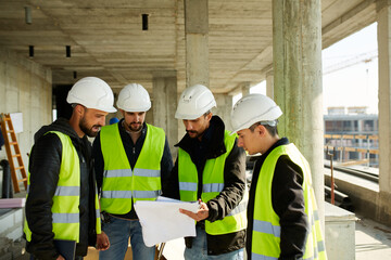Engineering team discussing project on site