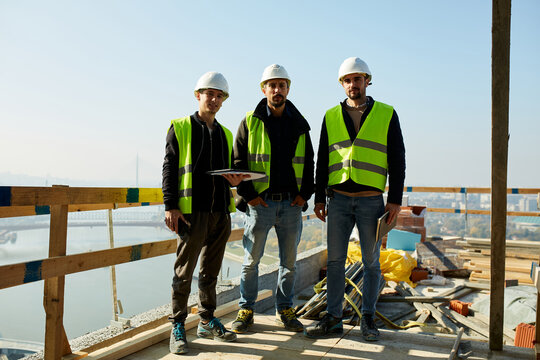 Team of civil engineers on top of a building