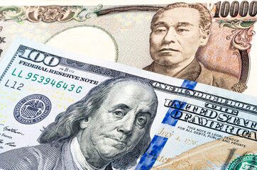 100 US dollar and 10000 yen banknotes. International trade concept