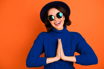 Close up photo of charming girl pretending to be praying while waiting for something being...