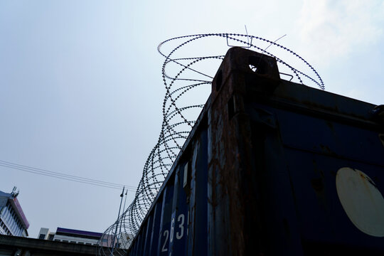 Barbed wire over a shipping container