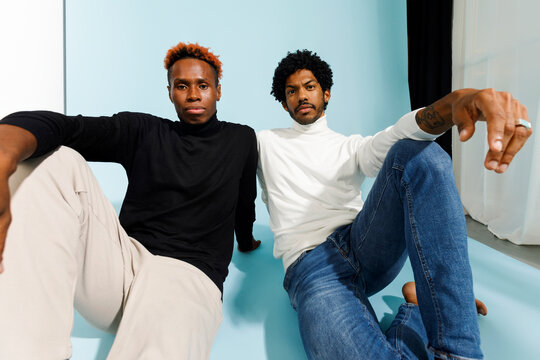 Two men posing casually together