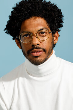 man with curly hair wearing glasses 