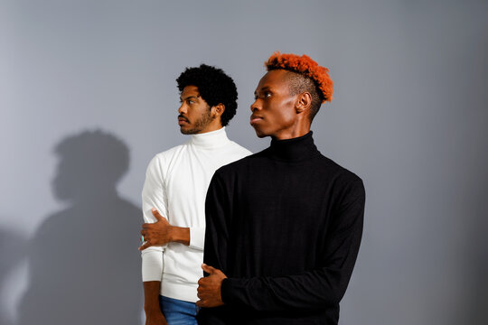 Two men in stylish turtlenecks 