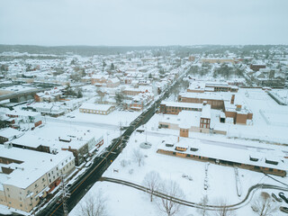 Aerial drone view of small town during a snow storm. Cinematic look. 