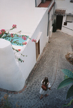 A woman walking in the streets of Zahara de la Sierra in Spain