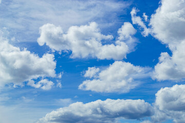 Magnificent cumulus clouds high in blue sky