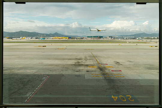 Airplane taking off over airport runway