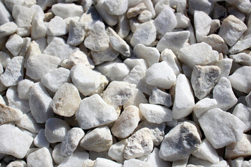 Close-up of white stones and pebbles in natural sunlight.